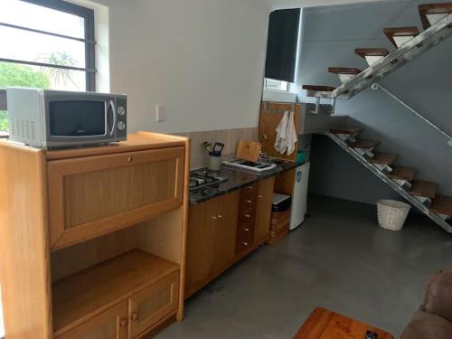 a kitchen with a tv on top of a counter at Bromley loft in Port Alfred