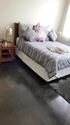 a bedroom with a bed and a side table at Gorgeous in Johannesburg
