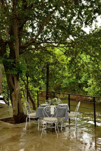 a table and chairs on a patio under a tree at Thanda Manzi Country Hotel in Centurion