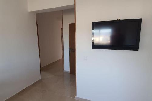 a room with a flat screen tv on a wall at Marjane Apartment 1 in Tetouan