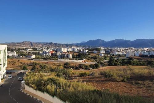 a view of a city with a road and buildings at Marjane Apartment 1 in Tétouan