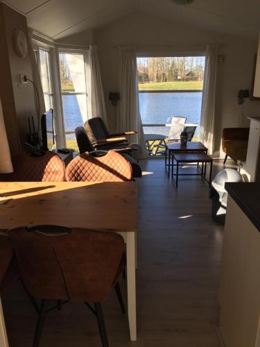a living room with a view of the water at 20A Hoofdweg in Midwolda