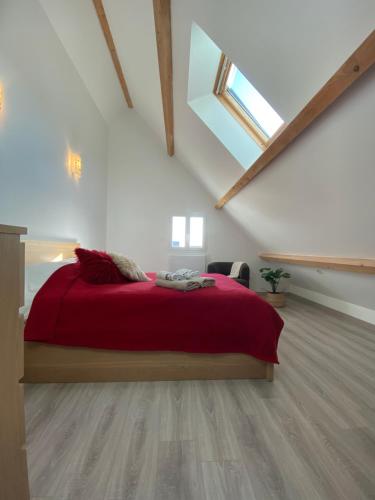 a bedroom with a red bed in a attic at T2 Duplex Châtelaillon-Plage in Châtelaillon-Plage