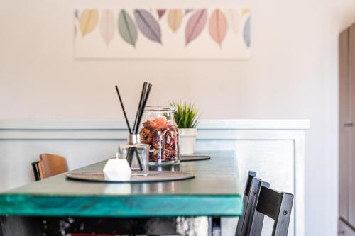 a dining room table with a green table at Nenes Studio in Koroni