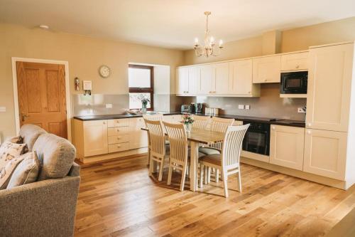 a kitchen and dining room with a table and chairs at The Shepherd's Rest in Thurso