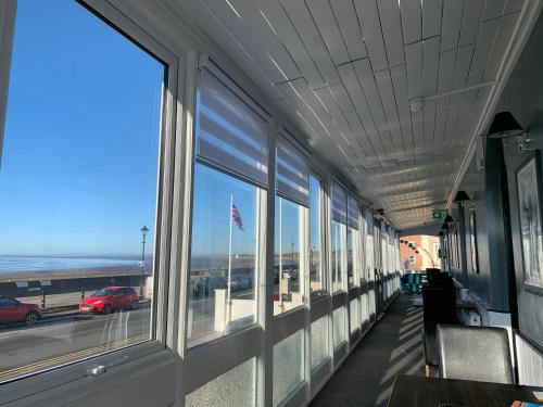 a hallway with windows and a view of a highway at The Royal Clarence Hotel (on the Seafront) in Burnham on Sea