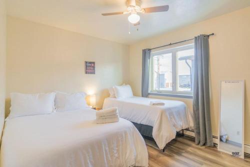 two white beds in a room with a window at Centrally Located Comfort And Coffee 3 in Fairbanks