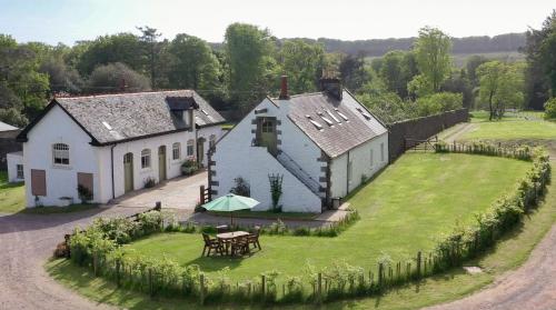 an aerial view of a house with a table in the yard at Stables Cottage in Stranraer