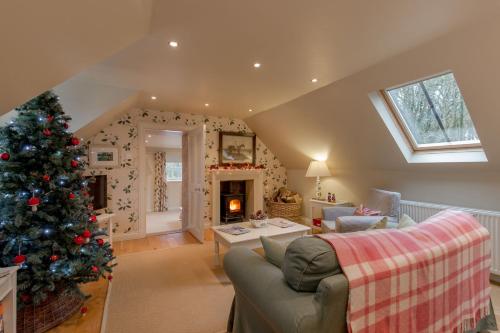 a living room with a christmas tree in it at Stables Cottage in Stranraer