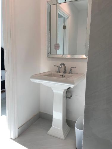 a bathroom with a white sink and a mirror at Boca Raton home in Boca Raton