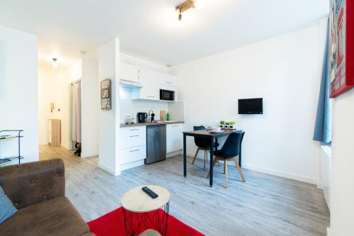 a living room with a couch and a table at Le Beteille in Rodez