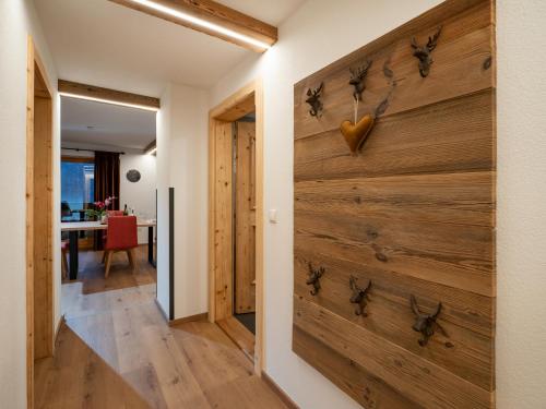 a hallway with a wooden wall with a heart on it at Bauernhof Vordermühltal in Itter