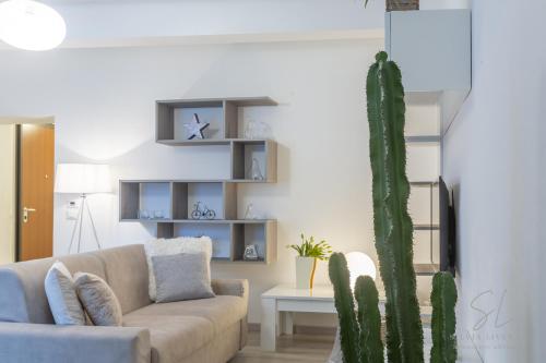 een woonkamer met een bank en een cactus bij Un'Oasi di Pace in Ferrara