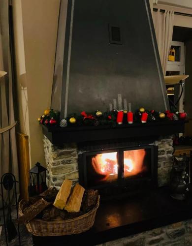 a fireplace with christmas decorations in a living room at De France by Thermalhotels in Leukerbad