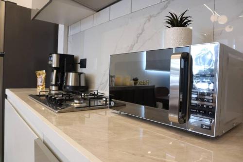 a microwave sitting on top of a kitchen counter at Luxurious and Central Apartment 2Br in Xalapa