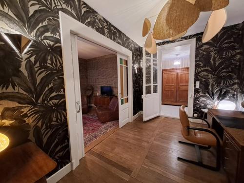 a hallway with black and white wallpaper at Les Colibris - Standing et Jardin - 3 étoiles in Cluses