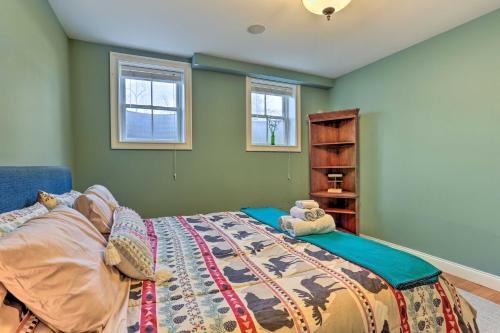 a bedroom with a bed and two windows at New Jersey Abode - Near the Statue of Liberty in Haskell