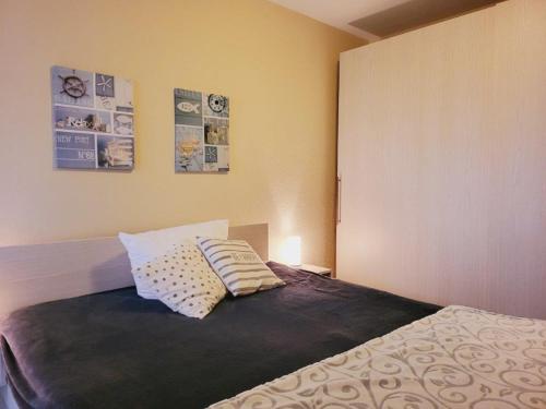 ein Schlafzimmer mit einem Bett mit zwei Kissen darauf in der Unterkunft Appartementhaus Ulmenschloesschen in Kühlungsborn