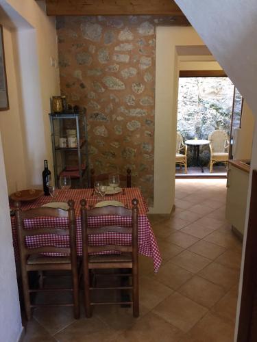 a dining room with a table and chairs in a room at Ca na Francina in Valldemossa