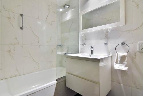 een witte badkamer met een wastafel en een douche bij Recoleta excelente ubicación in Buenos Aires