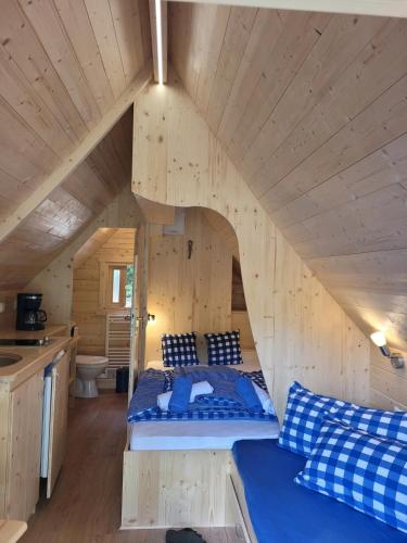 a bedroom in a log cabin with a bed in it at Gästehaus Bommelsen - Heidevilla in Walsrode