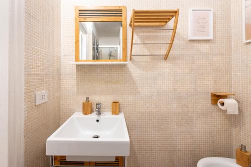 a bathroom with a sink and a mirror and a toilet at Appartamento trastevere Roma in Rome