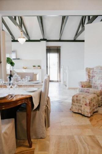 a dining room with a table and a chair at Marble Luxury Suites in Karteros