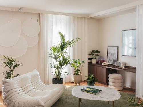 a living room with a white couch and a table at Seven Hotel Paris in Paris