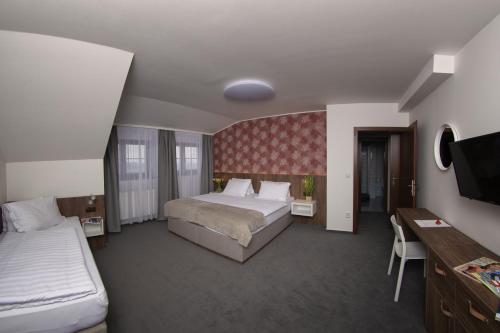 Postel nebo postele na pokoji v ubytování Hotel Prichovice