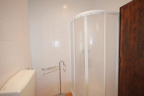 a shower in a bathroom with a toilet and a tub at T2 Casa dos Arcos by Seewest in Salema