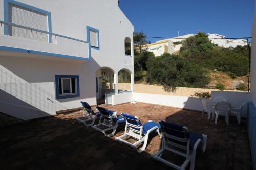 a group of chairs and tables on a patio at T2 Casa dos Arcos by Seewest in Salema