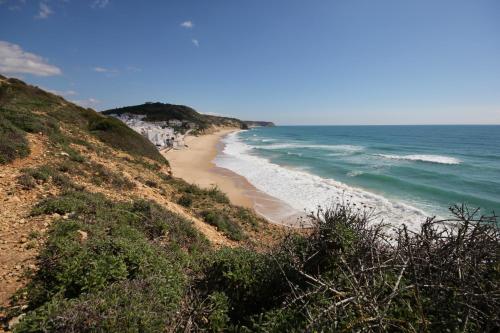 a view of a beach from a hill with the ocean at T2 Casa dos Arcos by Seewest in Salema