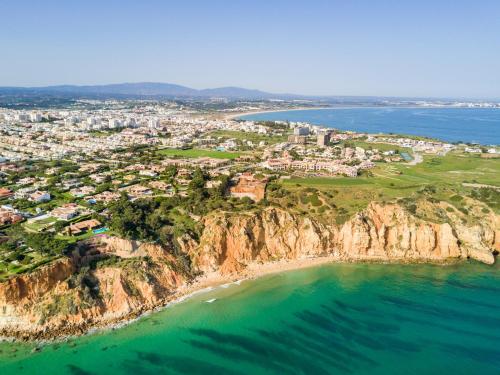 an aerial view of a city on a cliff over the ocean at T2 Casa dos Arcos by Seewest in Salema