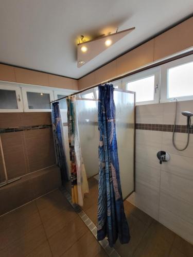 a bathroom with a shower with curtains in it at EASY Lodges Berlin in Berlin