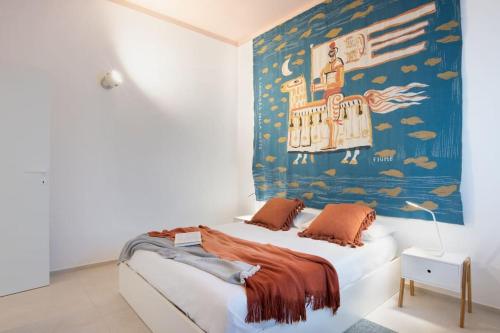 Villa LAVINIA MARE E PISCINA PRIVATA في Plaia Grande: غرفة نوم بسرير مع لوحة على الحائط