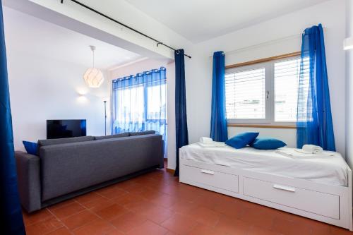 a bedroom with a bed and a couch and a window at Marina Lovers by Seewest in Lagos