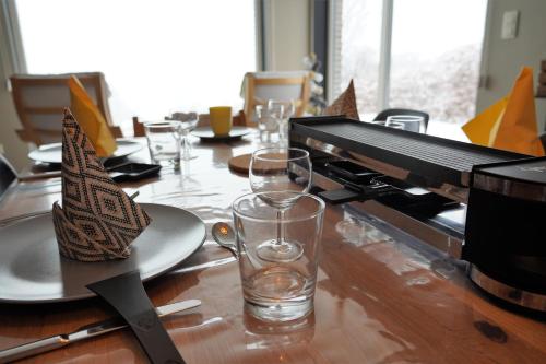 a piano sitting on a table with a plate and a glass at "Petite perle en Haute Ardenne" avec vue sur la vallée, cabine infra-rouge et bain balnéo in Lierneux