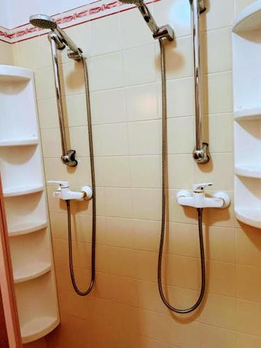 a bathroom with two sinks and a shower at Solar das Mimosas 2 casas in Sintra