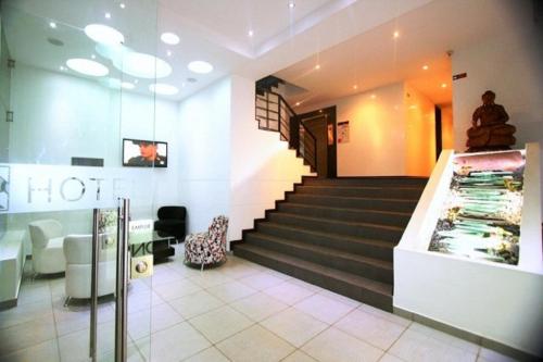 a lobby of a store with a staircase and a lobby at AW Hotel Ariston in Bogotá