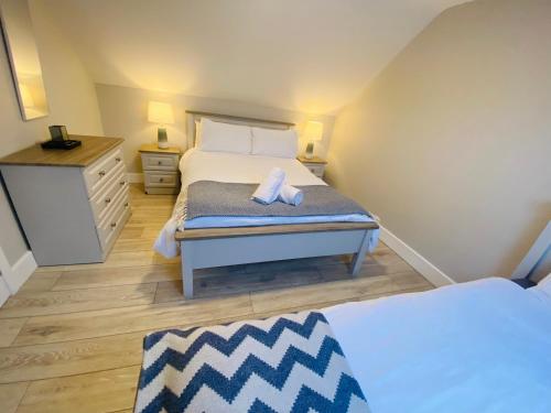 ein Schlafzimmer mit einem Bett mit zwei Handtüchern darauf in der Unterkunft Beside the sea & minutes from Cliffs-Clahane Shore Lodge in Liscannor