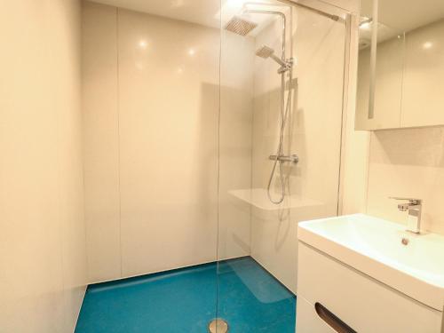 a bathroom with a shower and a blue floor at The Granary in Norwich
