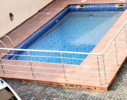 an overhead view of a swimming pool with a metal framework at Beautiful Town House in Lagos