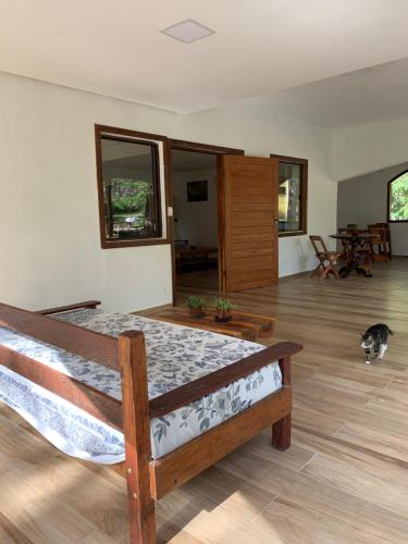 a bedroom with a bed and a cat in a room at Pousada Canto das Cachoeiras in Vale do Capao
