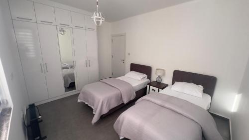 a bedroom with two beds and a mirror at Nicosia’s pearl in North Nicosia