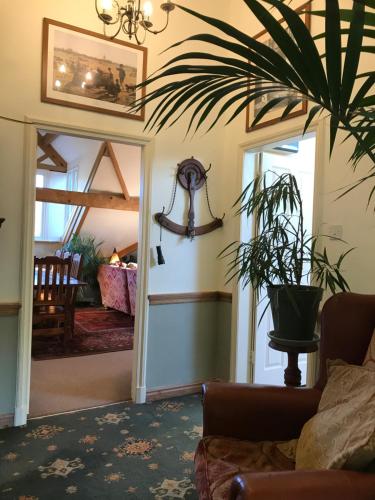 a living room with a couch and a plant at Large Ingleton Apartment, Yorkshire Dales, Three Peaks in Ingleton 