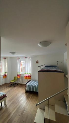 a bedroom with two beds and a table at Al BELVEDER in Levico Terme