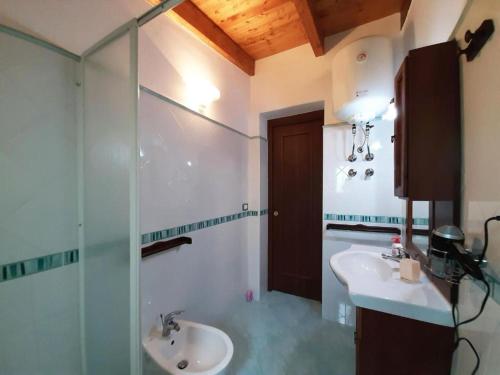 a bathroom with a sink and a glass shower at Garden & Sea in Vulcano