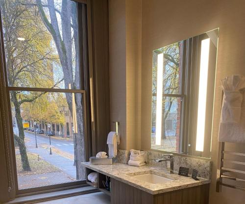 a bathroom with a sink and a large window at Harlow Hotel in Portland