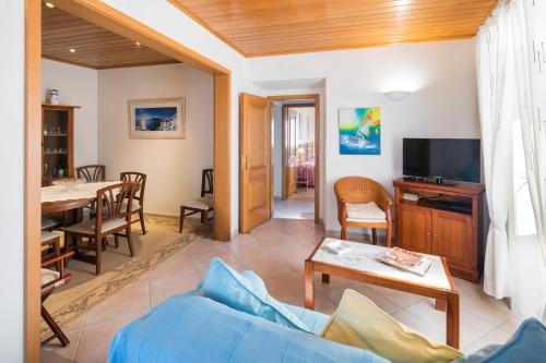 a living room with a blue couch and a table at Private 2 Bed Apartment in Albufeira Old Town in Albufeira