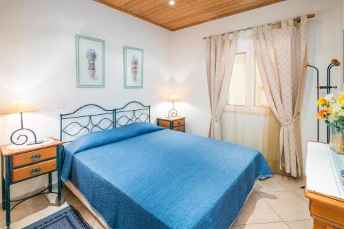 a bedroom with a blue bed and a window at Private 2 Bed Apartment in Albufeira Old Town in Albufeira